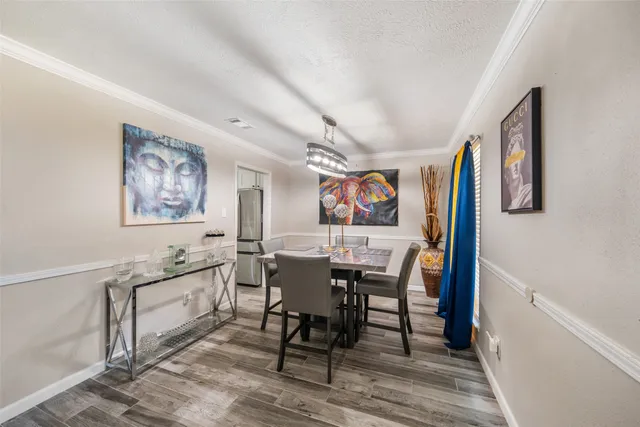 a view of a dining room with furniture and wooden floor