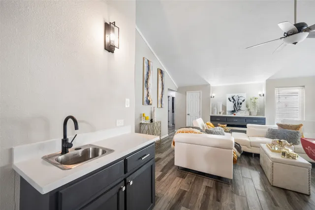 a living room with furniture and a mirror