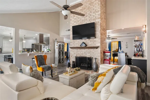 a living room with furniture a flat screen tv and a fireplace