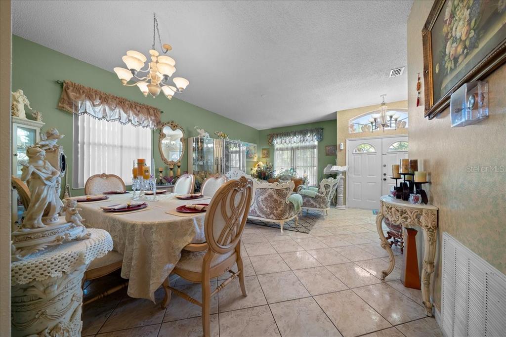 1010 Raining Meadows Lane Orlando, FL 32824 - Photo 11 of 57 a view of a dining room with furniture