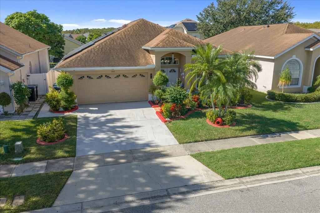 1010 Raining Meadows Lane Orlando, FL 32824 - Photo 2 of 57 a front view of a house with a yard and potted plants