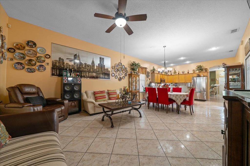 1010 Raining Meadows Lane Orlando, FL 32824 - Photo 22 of 57 a living room with lots of furniture and a chandelier