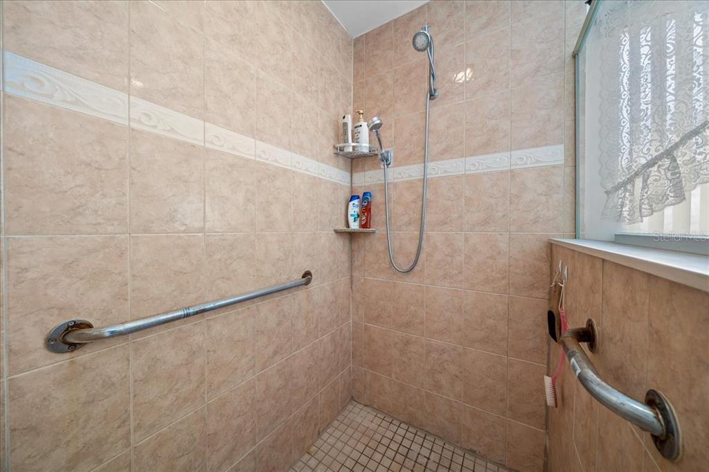 1010 Raining Meadows Lane Orlando, FL 32824 - Photo 30 of 57 a bathroom with a shower