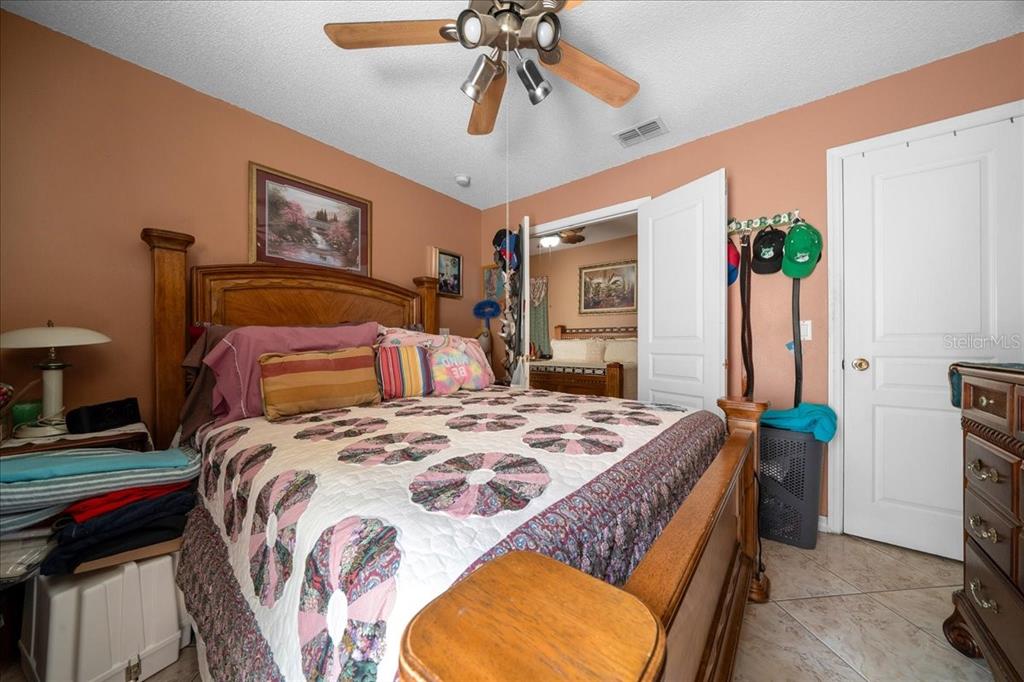 1010 Raining Meadows Lane Orlando, FL 32824 - Photo 31 of 57 a bedroom with bed and a chandelier