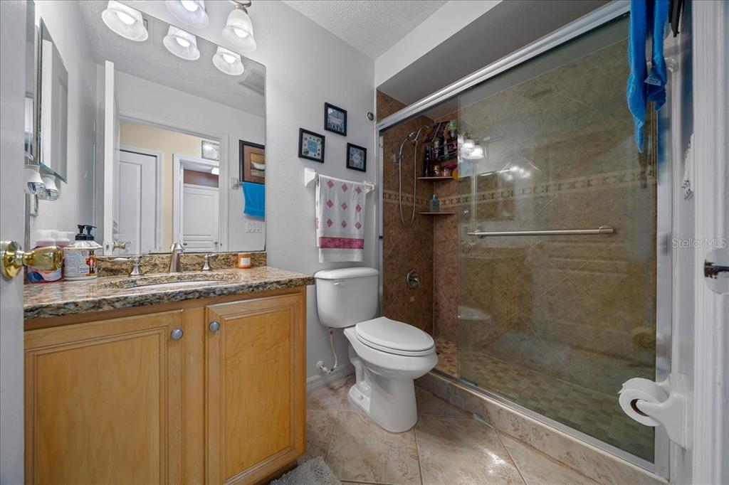 1010 Raining Meadows Lane Orlando, FL 32824 - Photo 34 of 57 a bathroom with a shower sink vanity mirror and toilet