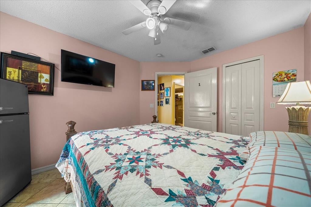 1010 Raining Meadows Lane Orlando, FL 32824 - Photo 36 of 57 a bedroom with a bed and a flat screen tv