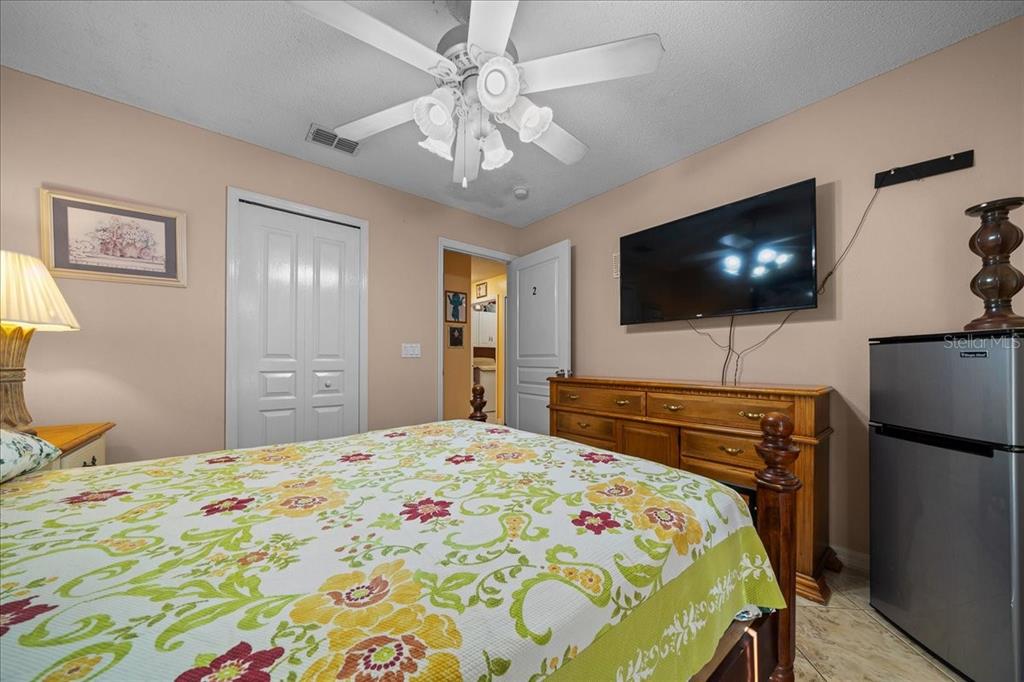 1010 Raining Meadows Lane Orlando, FL 32824 - Photo 38 of 57 a bedroom with a bed and a flat screen tv