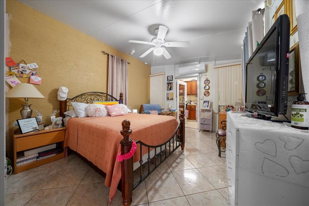 1010 Raining Meadows Lane Orlando, FL 32824 - Photo 41 of 57 a bedroom with a bed and a chandelier