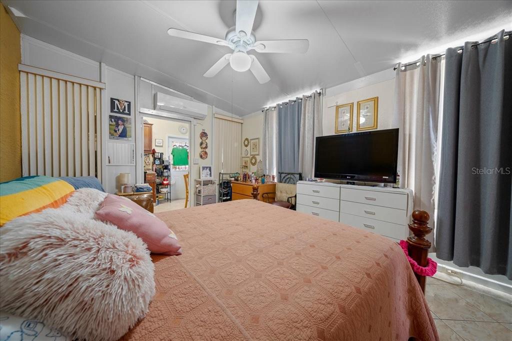 1010 Raining Meadows Lane Orlando, FL 32824 - Photo 42 of 57 a bed room with a bed television and a flat tv screen