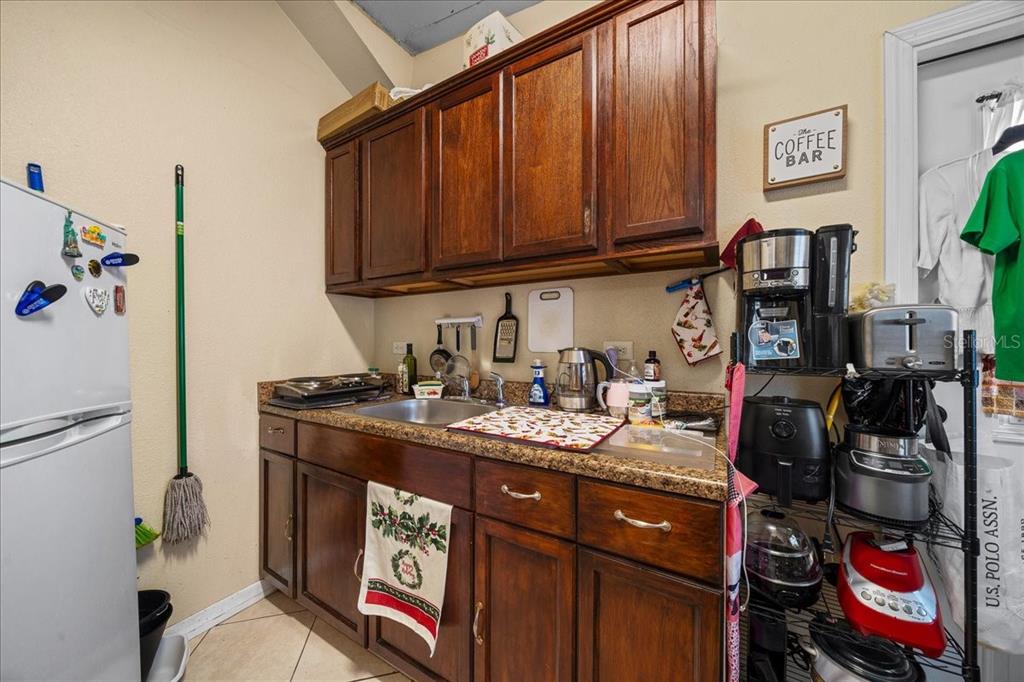 1010 Raining Meadows Lane Orlando, FL 32824 - Photo 46 of 57 a kitchen with stainless steel appliances granite countertop a sink stove and cabinets