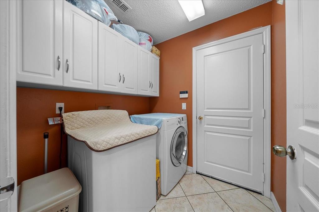 1010 Raining Meadows Lane Orlando, FL 32824 - Photo 47 of 57 a utility room with dryer and washer