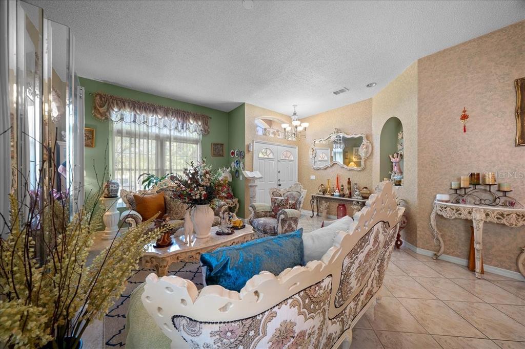 1010 Raining Meadows Lane Orlando, FL 32824 - Photo 8 of 57 a living room with furniture a large window and chairs