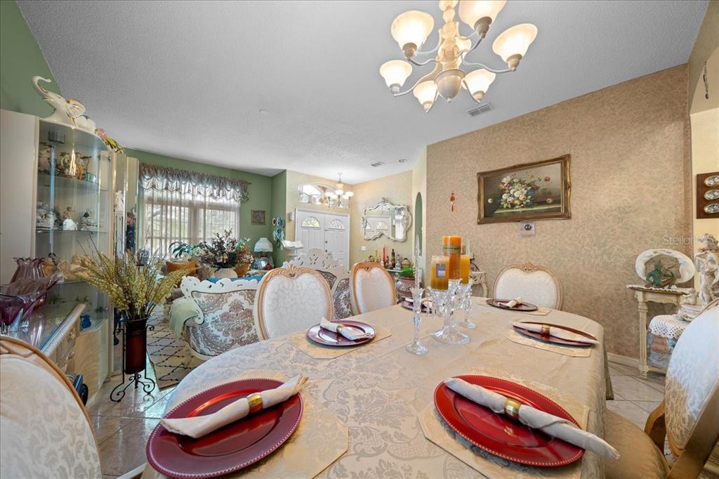1010 Raining Meadows Lane Orlando, FL 32824 - Photo 10 of 57 a view of a dining room with furniture