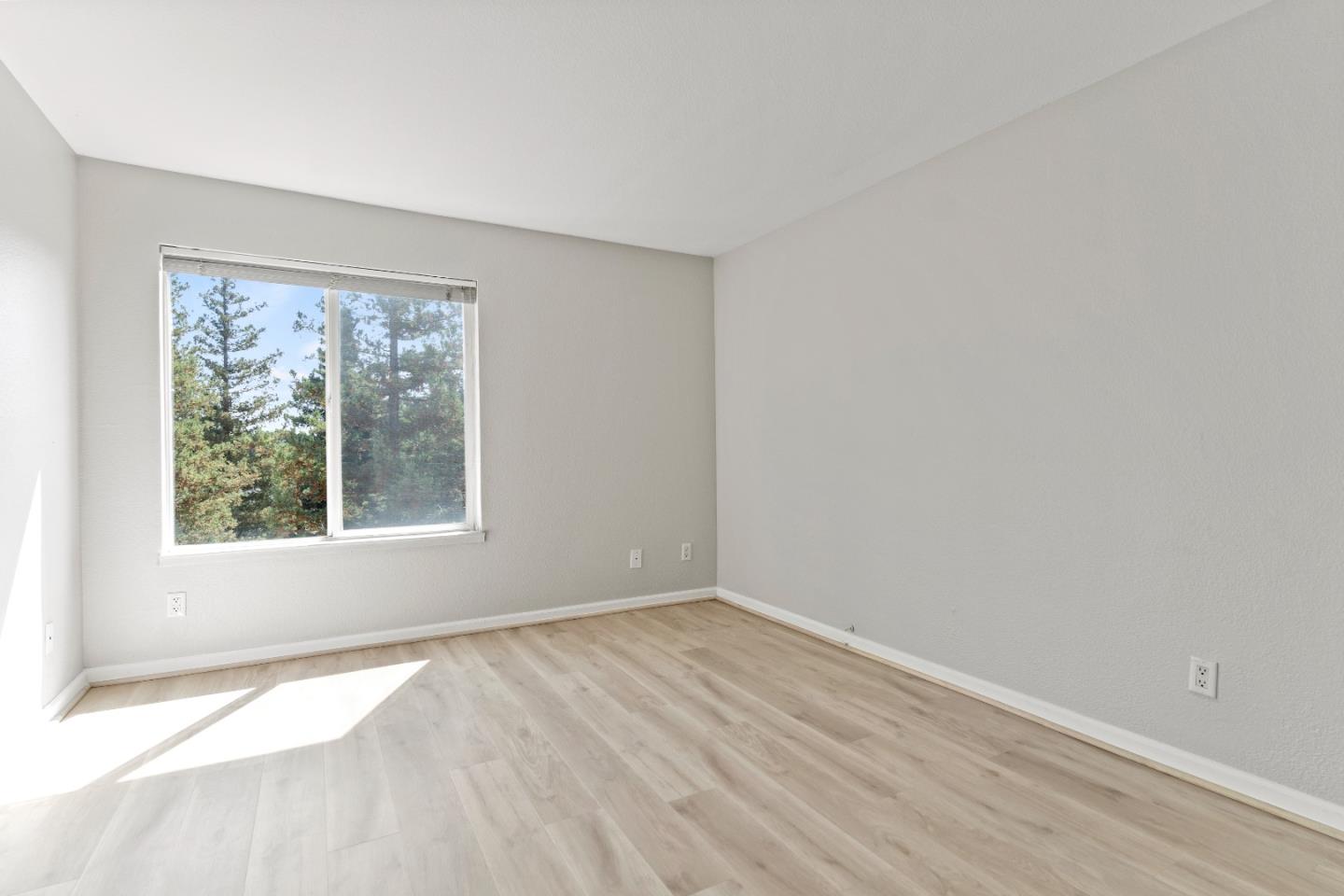 29581 Highgate Drive, Unit 219 Hayward, CA 94544 - Photo 15 of 24 an empty room with wooden floor and windows