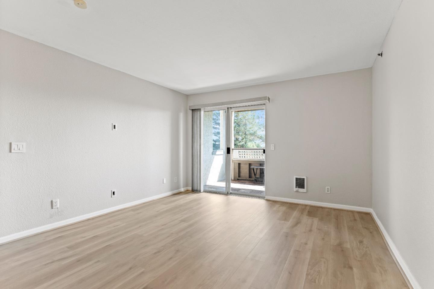 29581 Highgate Drive, Unit 219 Hayward, CA 94544 - Photo 6 of 24 a view of a room with wooden floor and windows