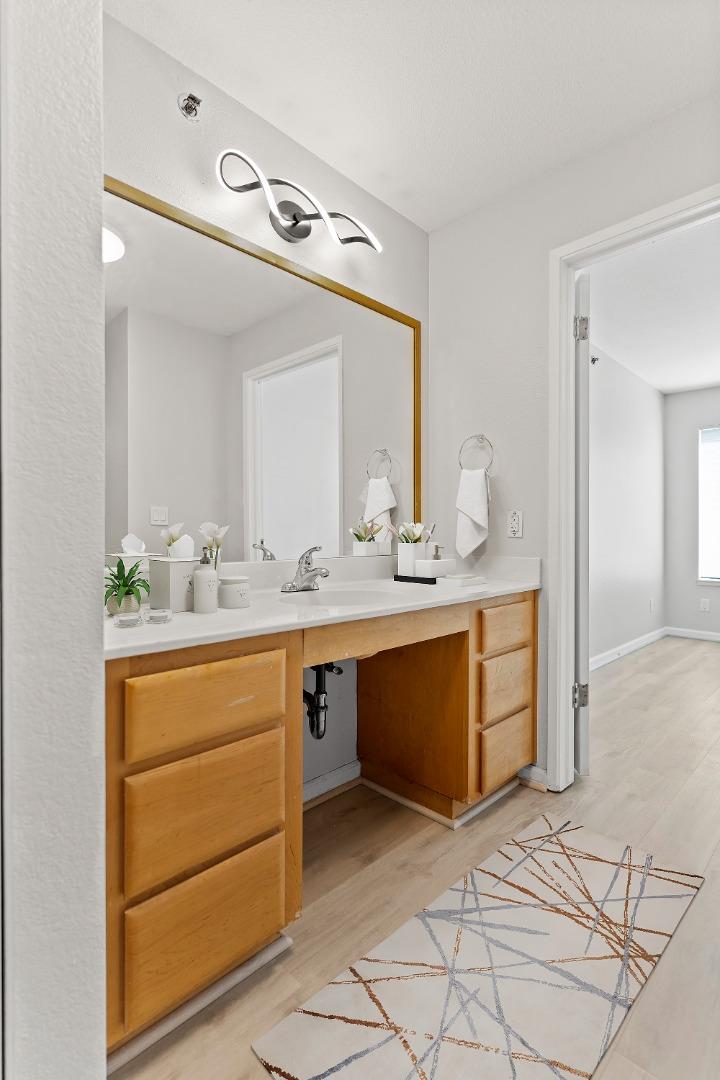 29581 Highgate Drive, Unit 219 Hayward, CA 94544 - Photo 10 of 24 a bathroom with a sink vanity and mirror