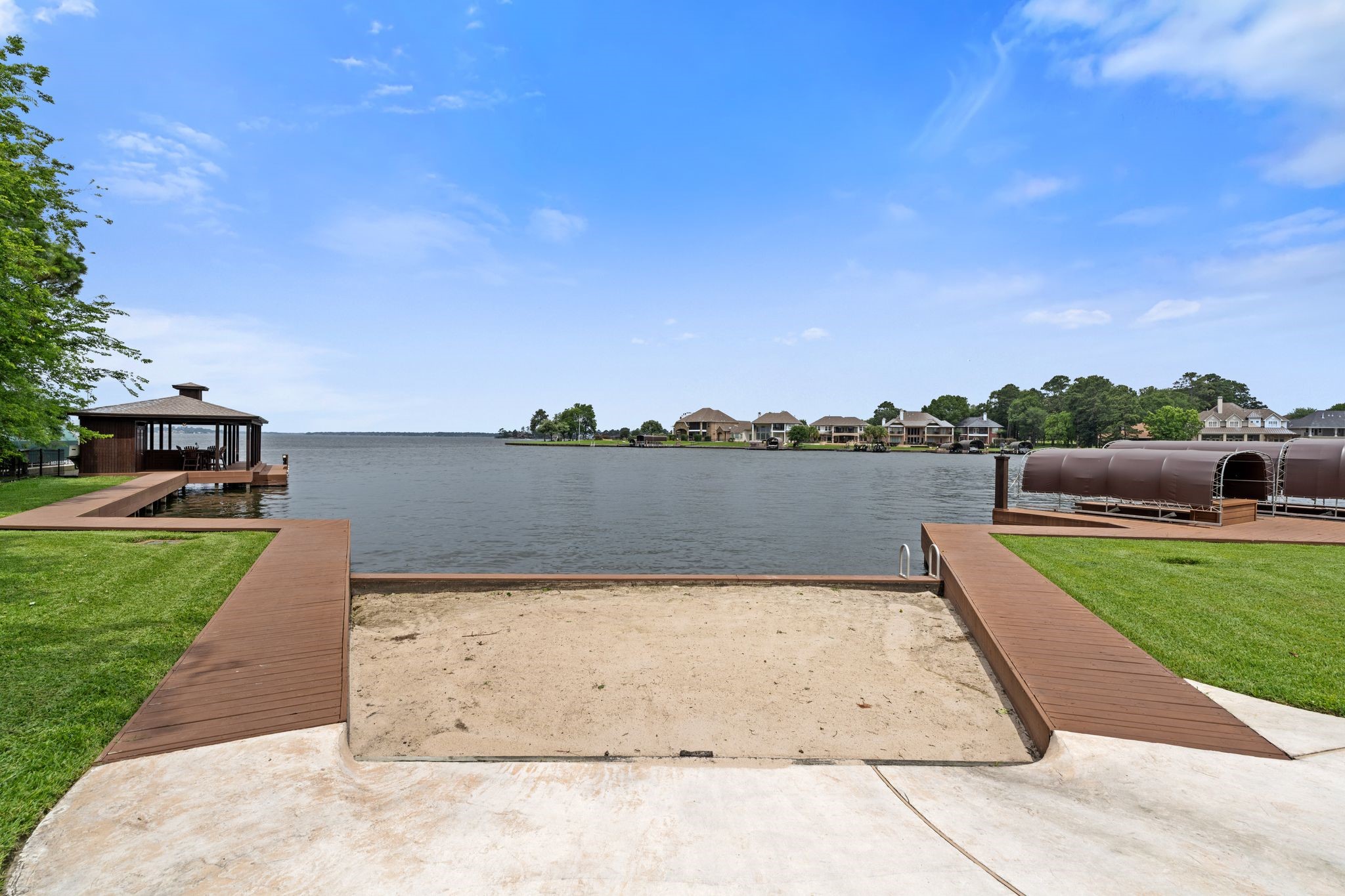 12349 Longmire Trace Conroe, TX 77304 - Photo 47 of 48 Private lakeside retreat with expansive dock, covered boat slip, and sweeping open-water views.