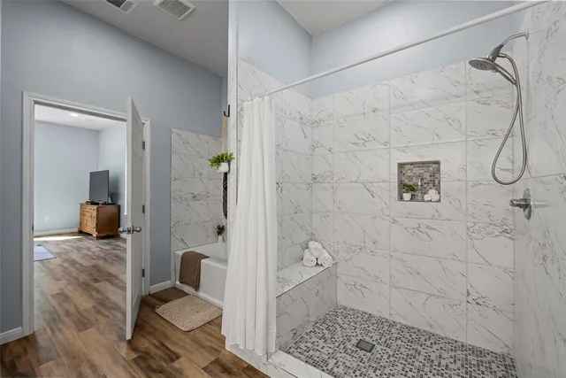 a bathroom with a granite countertop shower