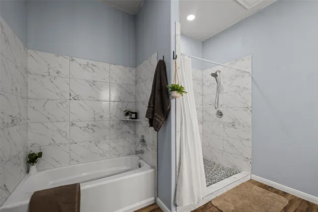 a bathroom with a tub and a shower