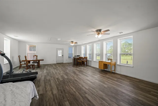 a living room with furniture and large windows