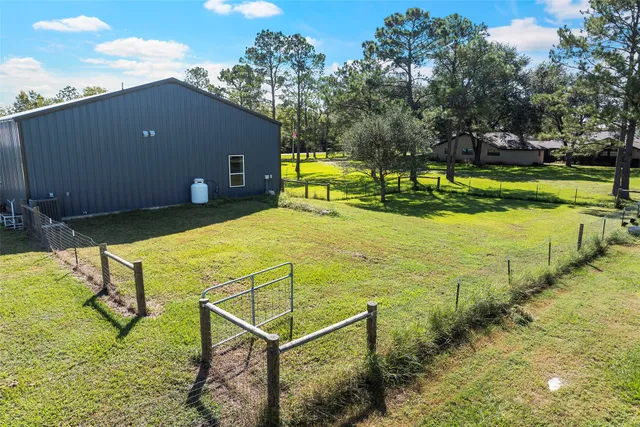 a view of a house with yard and swimming pool