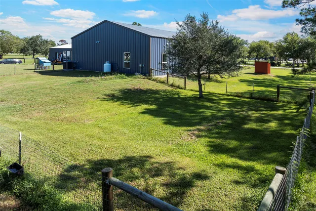 a backyard of a house with a yard and outdoor seating