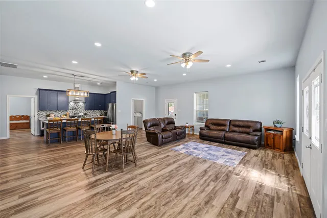 a living room with furniture and a wooden floor