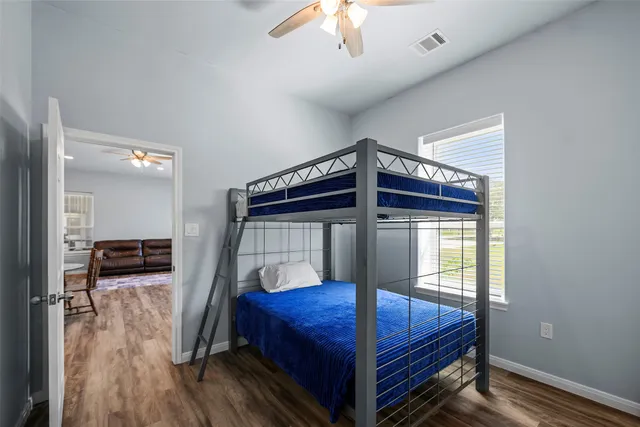 a bedroom with a bunk bed and a chandelier