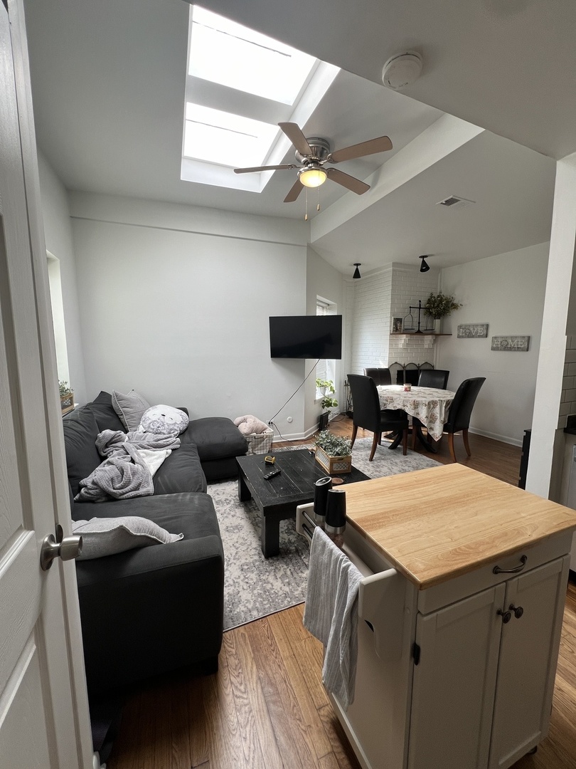 Undisclosed Address Chicago, IL 60657 - Photo 5 of 9 a living room with furniture and a flat screen tv