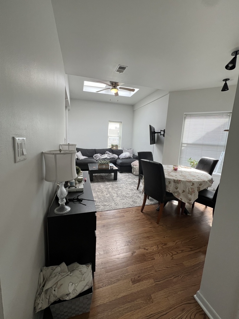 Undisclosed Address Chicago, IL 60657 - Photo 6 of 9 a living room with furniture and a chandelier
