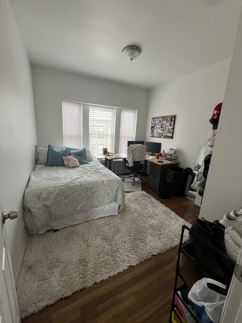 Undisclosed Address Chicago, IL 60657 - Photo 7 of 9 a bedroom with a bed and wooden floor