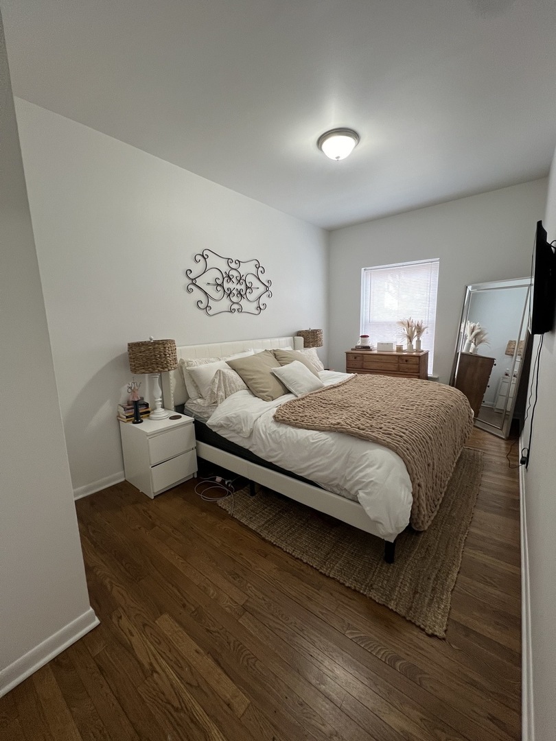 Undisclosed Address Chicago, IL 60657 - Photo 8 of 9 a bedroom with a bed and a night stand