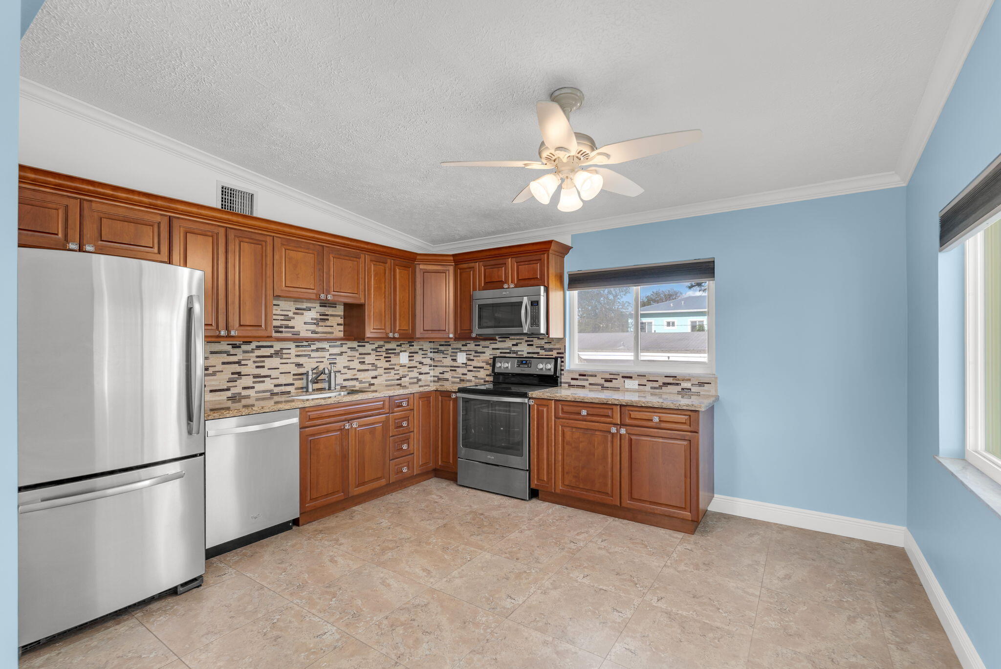 527 Sound Drive Key Largo, FL 33037 - Photo 24 of 50 a kitchen with stainless steel appliances granite countertop a refrigerator oven a sink dishwasher and a refrigerator with wooden floor