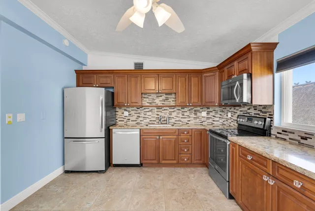 an empty room with closet and a chandelier fan