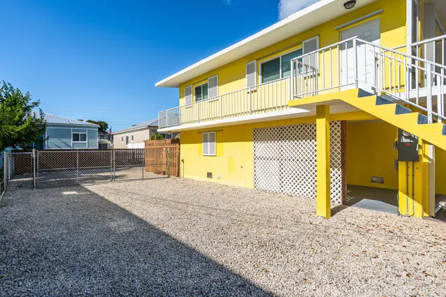 a view of a house with a wooden fence
