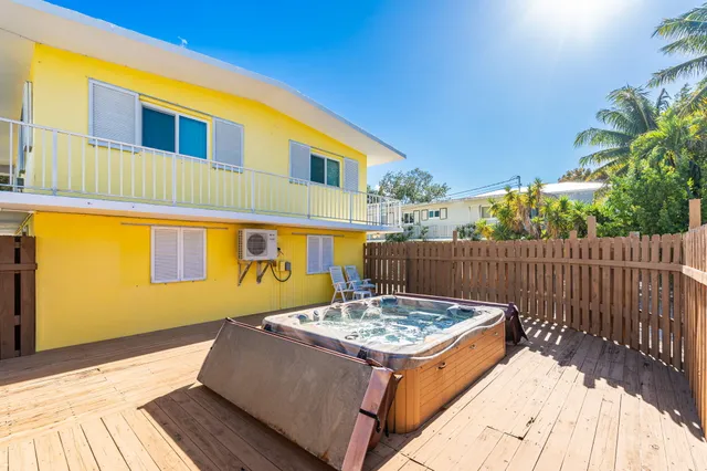 a view of a house with wooden fence