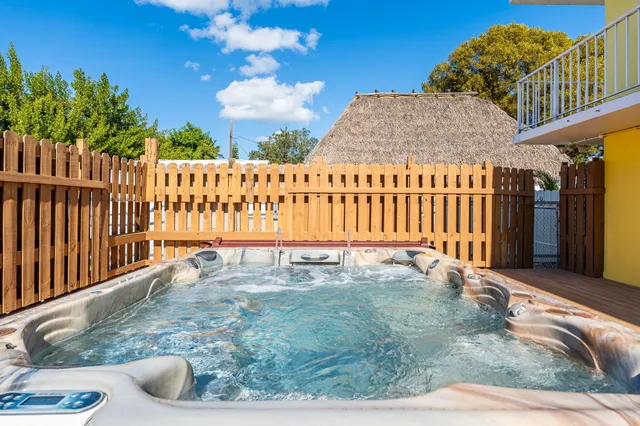 a view of a roof deck with wooden fence and wooden floor
