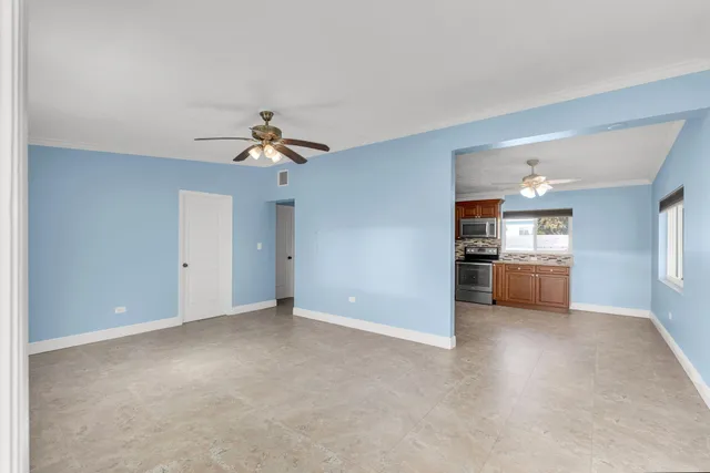 a view of a kitchen with a sink and a ceiling fan