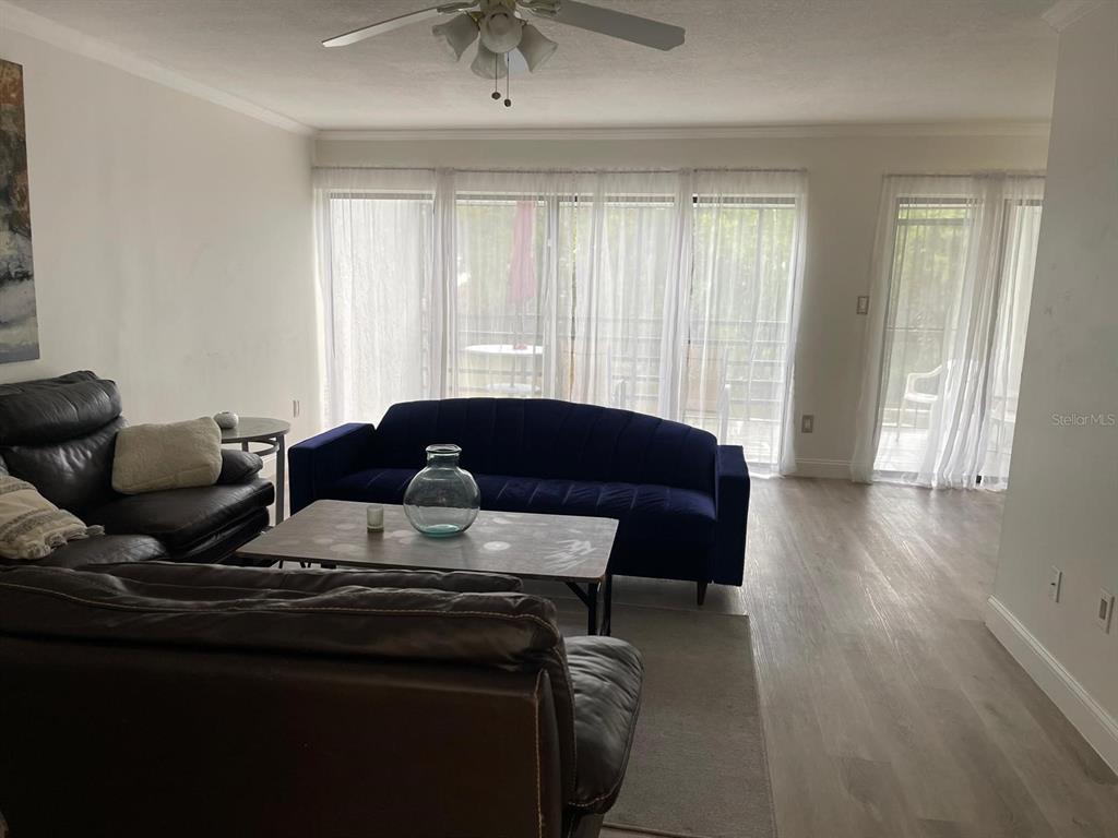 4559 Towerpine Road, Unit GE Orlando, FL 32839 - Photo 2 of 4 a living room with furniture and a window