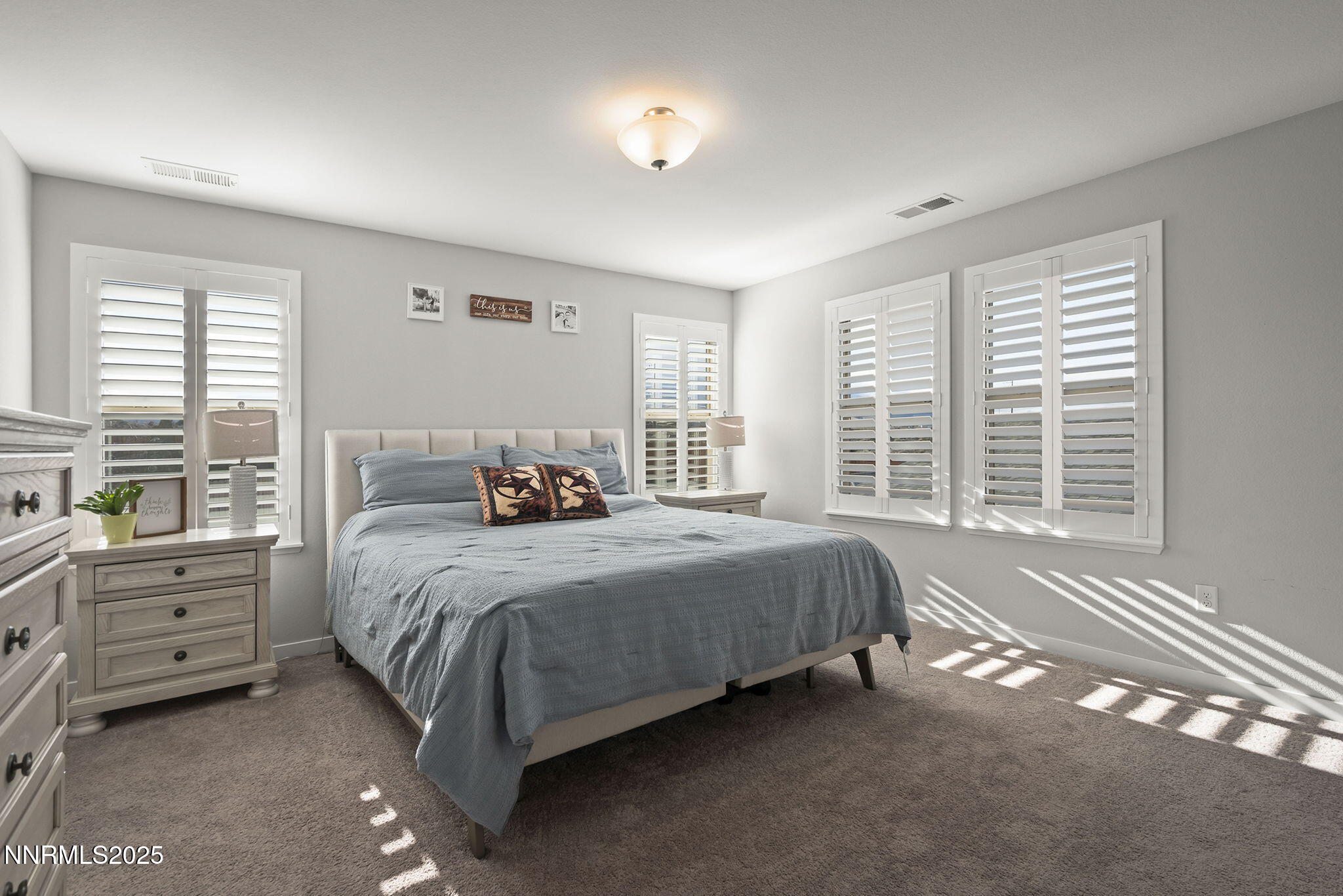 7181 Mustengo Drive Reno, NV 89506 - Photo 11 of 37 a spacious bedroom with a bed and a window