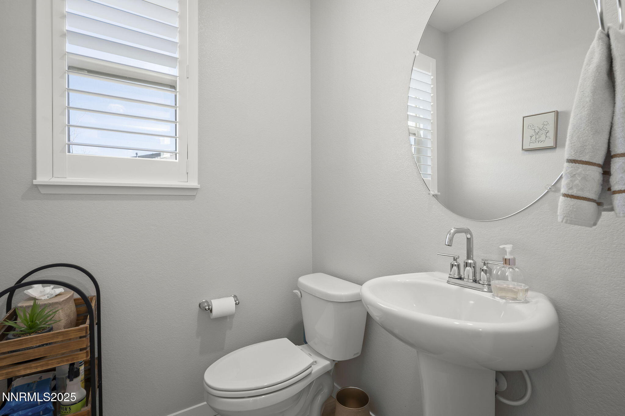 7181 Mustengo Drive Reno, NV 89506 - Photo 22 of 37 a bathroom with a toilet sink and mirror