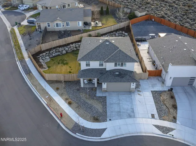 an aerial view of a house with a swimming pool