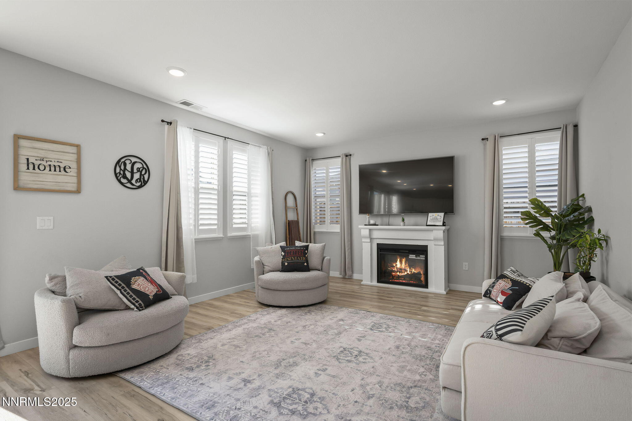 7181 Mustengo Drive Reno, NV 89506 - Photo 8 of 37 a living room with furniture a fireplace and a flat screen tv
