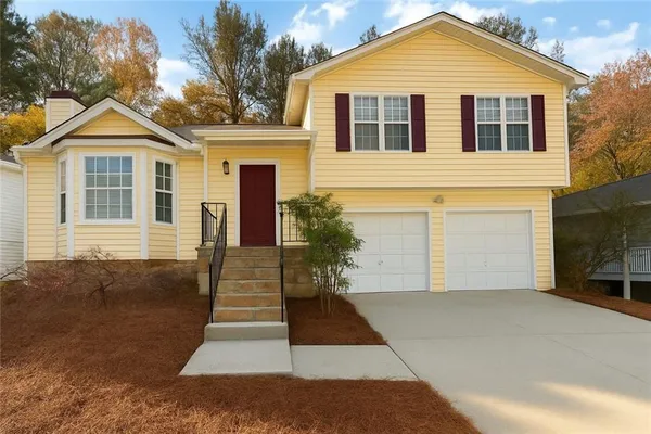 a front view of a house with a yard and garage