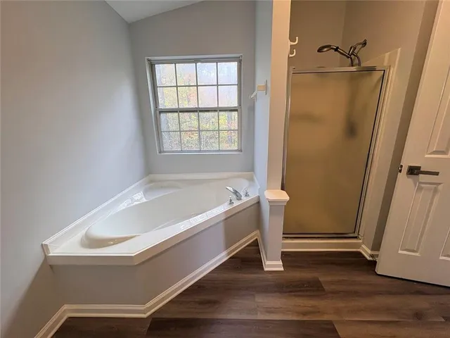 a bathroom with a tub and shower