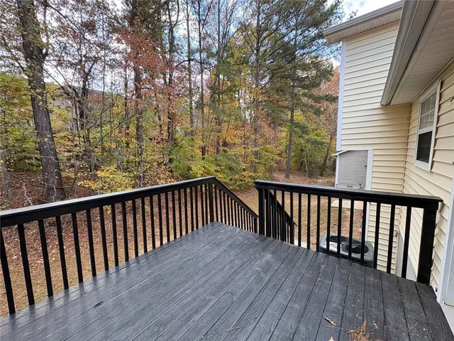 a view of balcony with wooden floor and fence