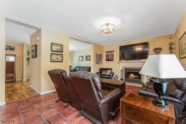 a living room with furniture a dining table and a potted plant