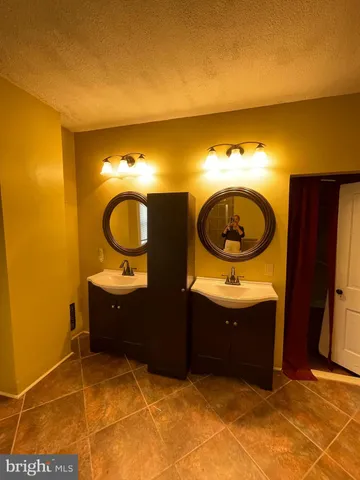 a bathroom with a sink mirror vanity and toilet