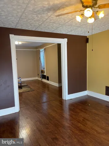 a view of a room with wooden floor