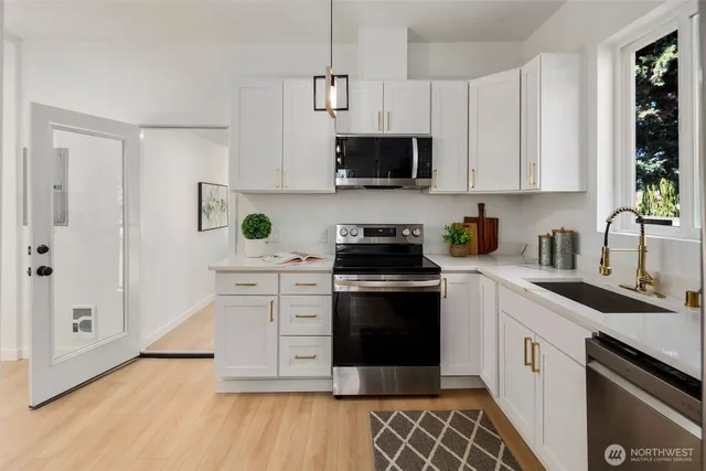 a view of a livingroom with furniture and a wooden floor